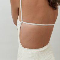 back detail of hakea textured cream Terrain One Piece shorty surfsuit — sustainable swimwear designed for support and comfort in the surf, flattering one piece surf suit for active women.