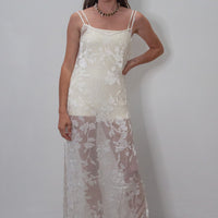 hakea textured cream Terrain One Piece shorty surfsuit layered with sheer silk dress for post surf.