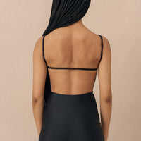 hakea black Terrain One Piece shorty surfsuit — sustainable swimwear designed for support and comfort in the surf, flattering one piece surf suit for active women.