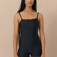 hakea black Terrain One Piece shorty surfsuit — sustainable swimwear designed for support and comfort in the surf, flattering one piece surf suit for active women.