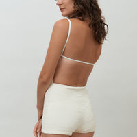 hakea textured cream Terrain One Piece shorty surfsuit — sustainable swimwear designed for support and comfort in the surf, flattering one piece surf suit for active women.